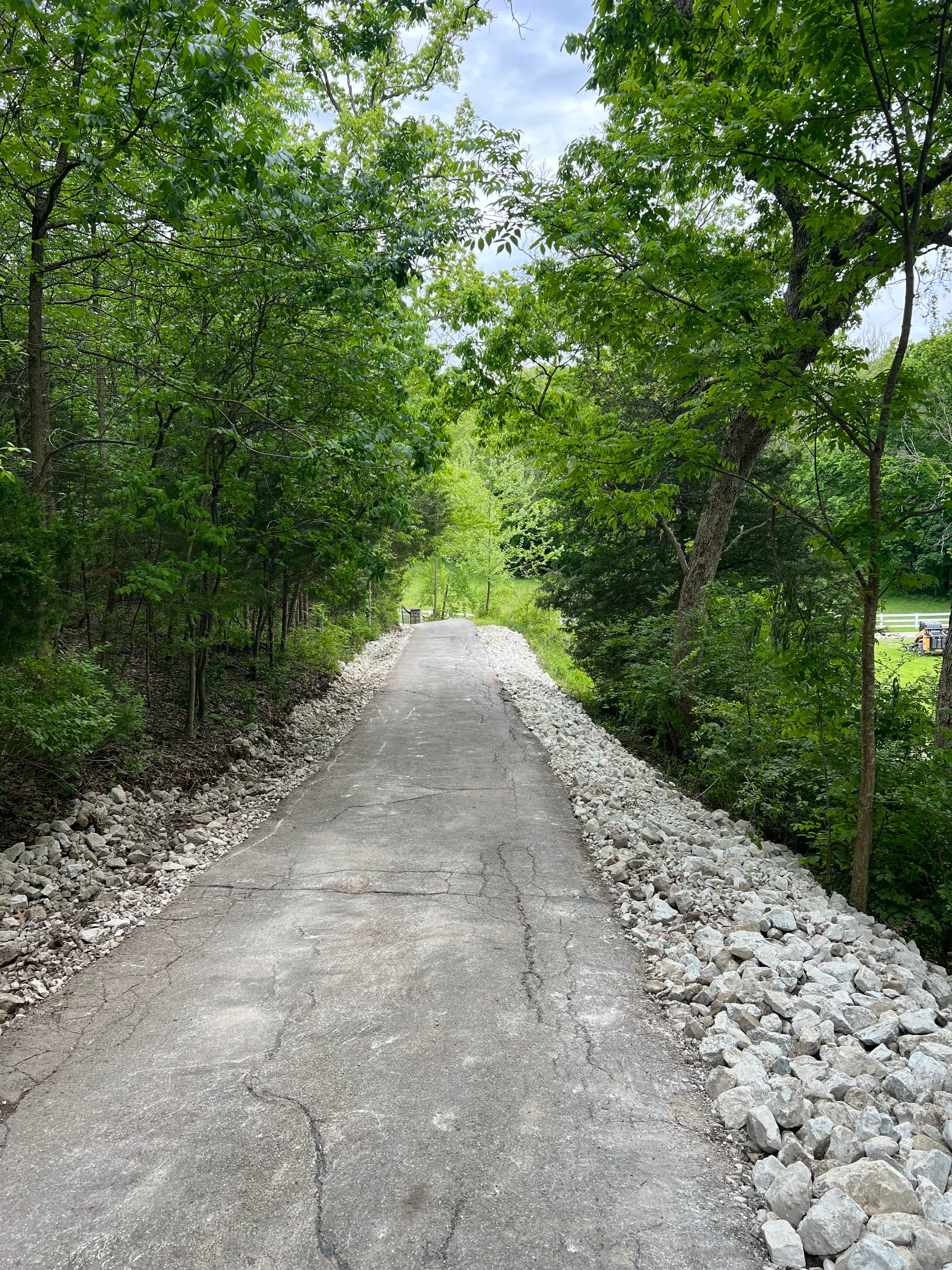 Steep Driveway Erosion Fixed With Regrading and Large Stone